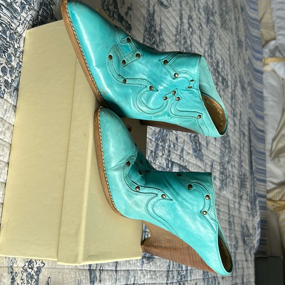 Cowboy wedge slides in the season’s hot turquoise color. 3” heel leather uppers